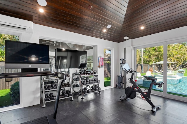 exercise room with lofted ceiling, a wall unit AC, and wooden ceiling