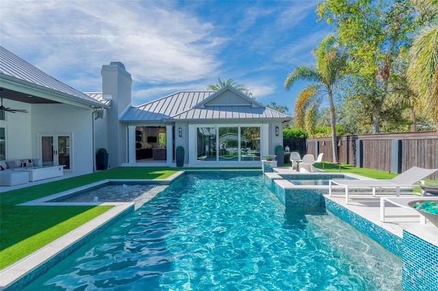 view of swimming pool with a patio area, a lawn, and an in ground hot tub