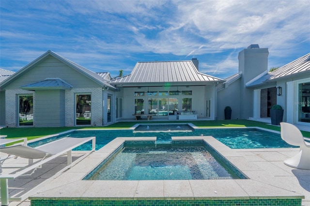 back of property featuring a patio area, ceiling fan, and a pool with hot tub