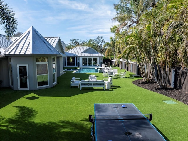 exterior space featuring a patio, a fenced in pool, and a lawn