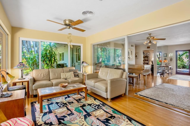 sunroom / solarium featuring ceiling fan