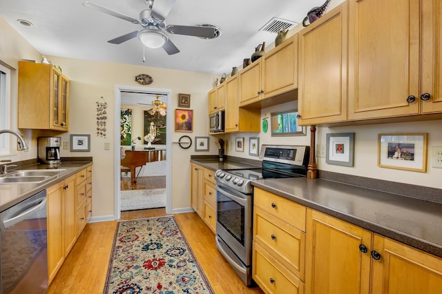 kitchen with sink, light hardwood / wood-style flooring, ceiling fan, and appliances with stainless steel finishes