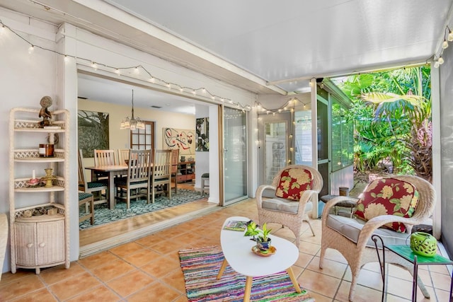 sunroom featuring an inviting chandelier