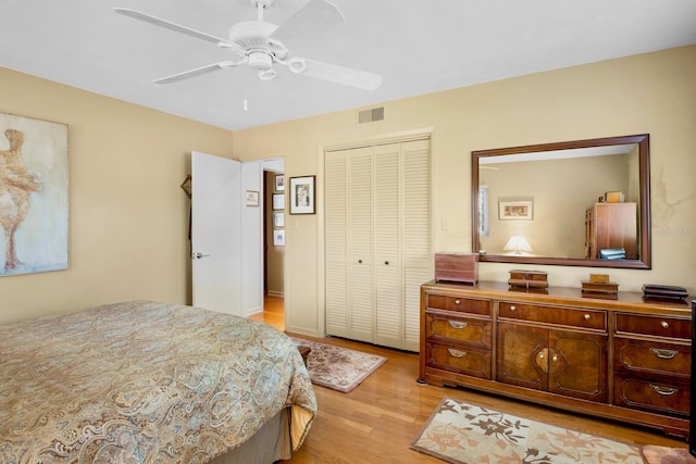 bedroom featuring ceiling fan, light hardwood / wood-style floors, and a closet