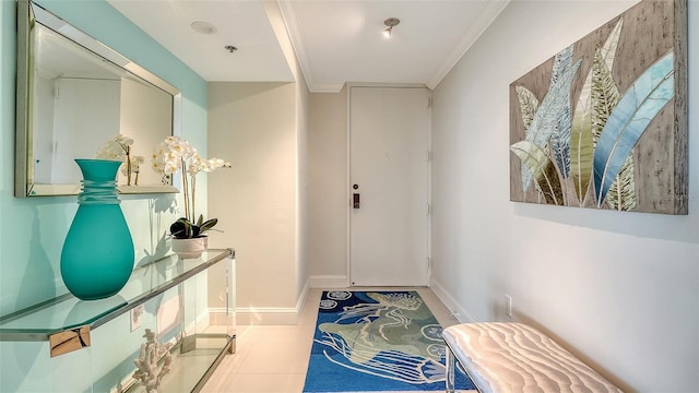 doorway featuring baseboards and ornamental molding