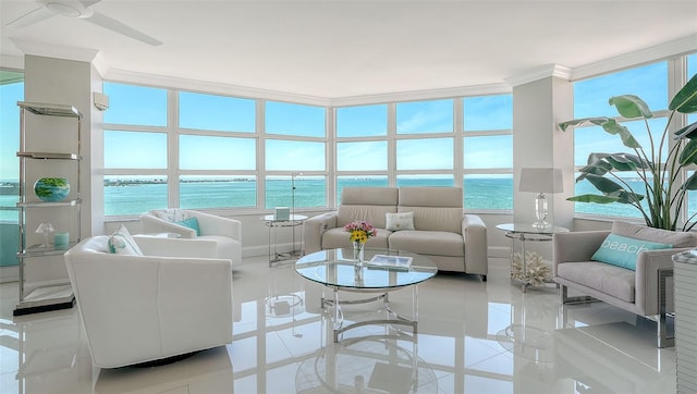 sunroom / solarium featuring plenty of natural light and a water view