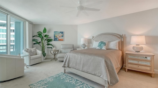 bedroom featuring light colored carpet and ceiling fan