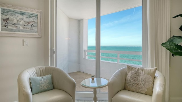 sitting room featuring a water view