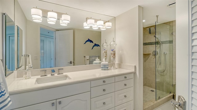 bathroom featuring a stall shower, visible vents, a closet, and vanity