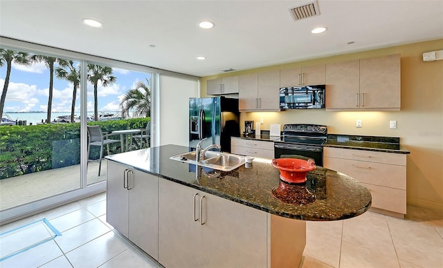 kitchen featuring light tile patterned floors, black appliances, a sink, and visible vents