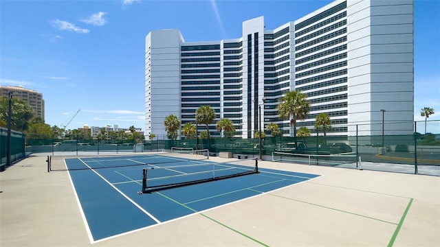 view of sport court featuring fence