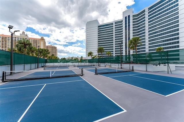 view of tennis court featuring fence