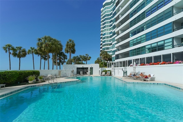 pool with fence and a patio