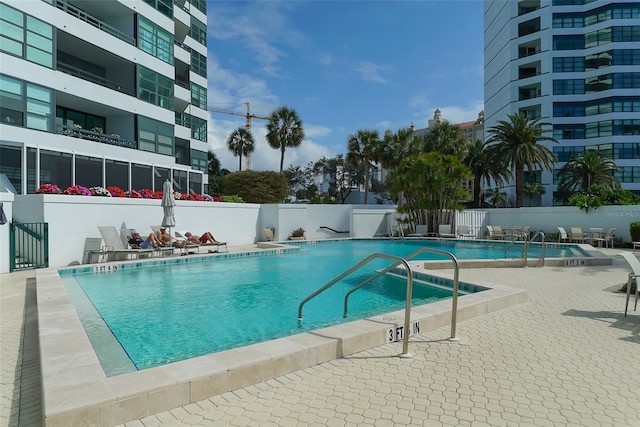 community pool featuring a patio area and fence