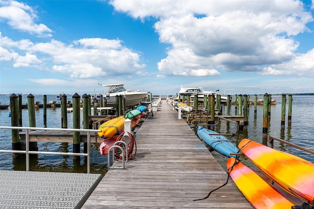 dock area with a water view and boat lift