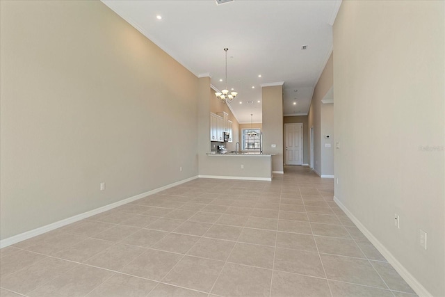 unfurnished living room with light tile patterned floors, ornamental molding, sink, and a chandelier