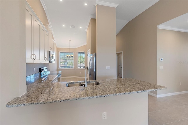 kitchen featuring sink, appliances with stainless steel finishes, light stone counters, white cabinets, and kitchen peninsula