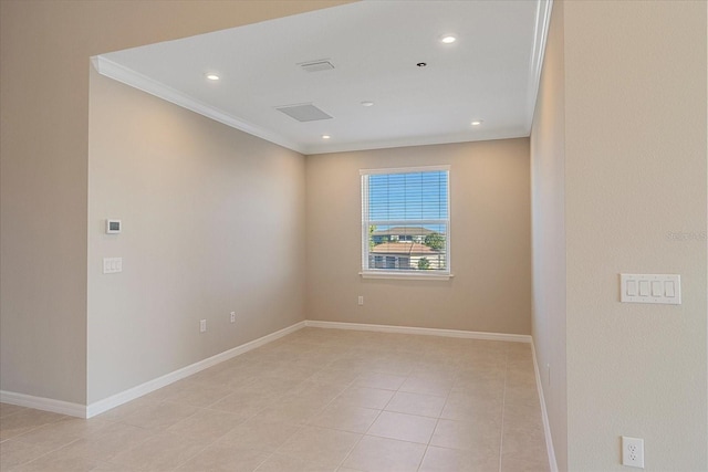 tiled spare room with crown molding