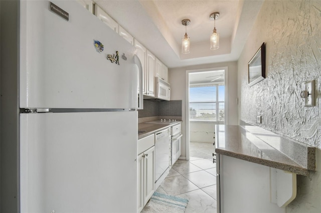 kitchen featuring light tile patterned floors, white appliances, white cabinetry, hanging light fixtures, and a raised ceiling