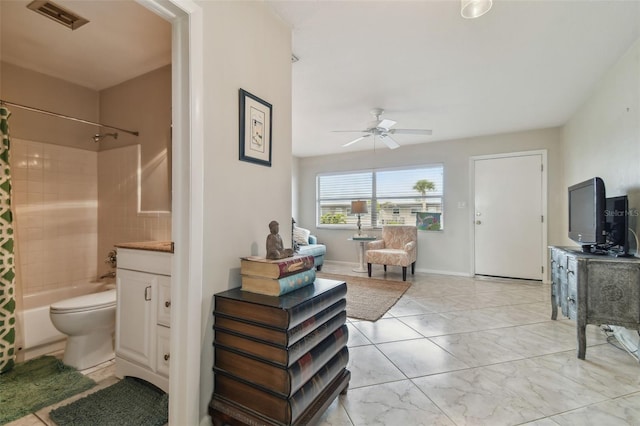 full bathroom featuring vanity, shower / tub combo with curtain, ceiling fan, and toilet