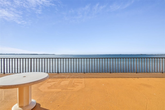 view of patio / terrace with a water view and a balcony