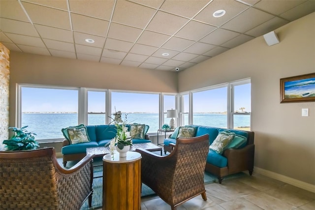 interior space with a paneled ceiling and a water view