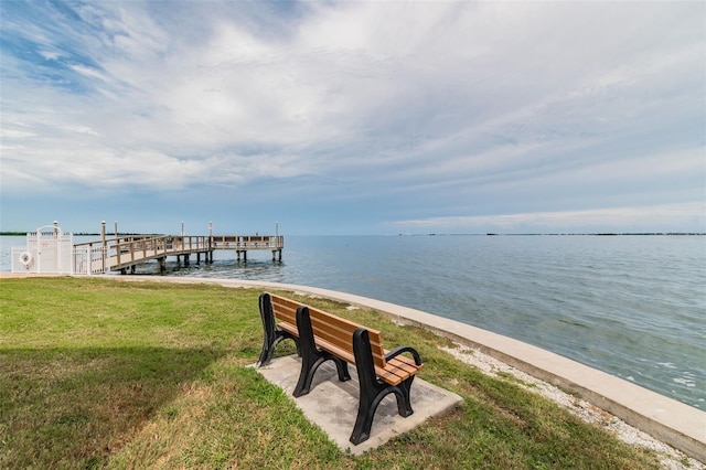 view of dock featuring a water view and a lawn