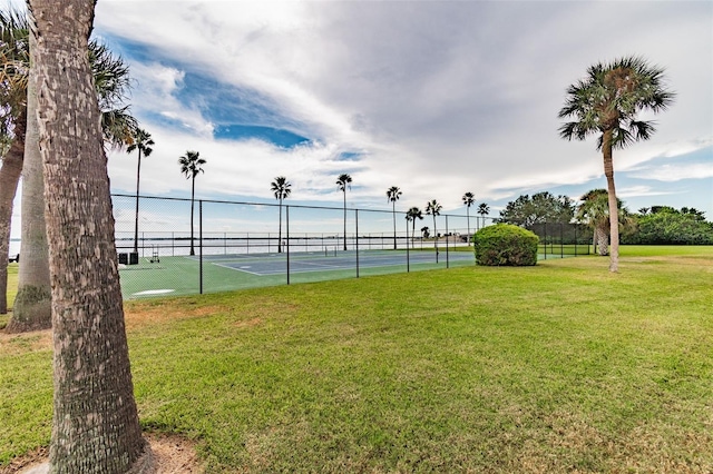 view of sport court featuring a yard