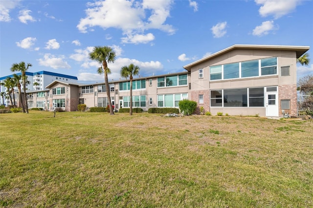 rear view of property with a yard