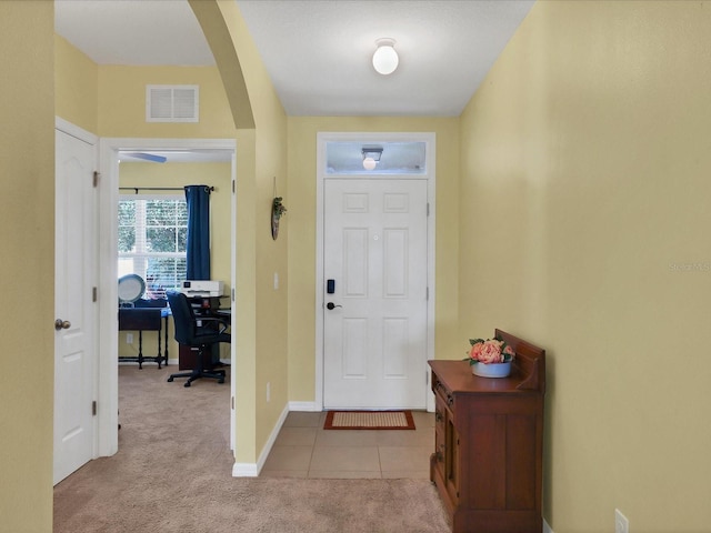 entryway featuring light colored carpet