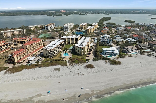 birds eye view of property featuring a water view and a beach view