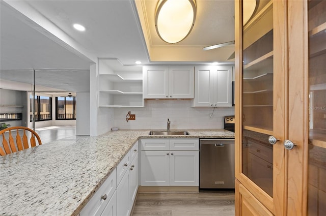 kitchen with white cabinetry, dishwasher, and sink