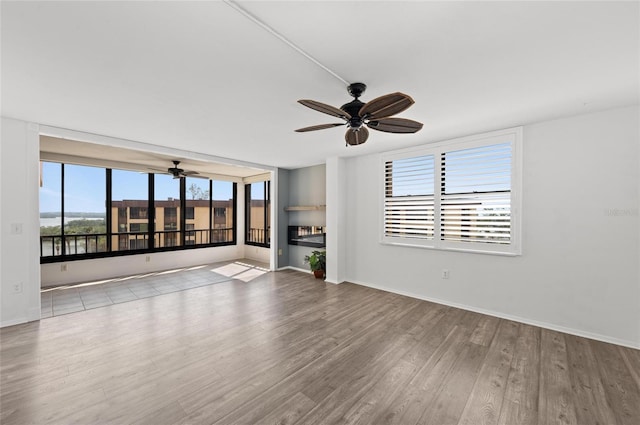 unfurnished living room with light hardwood / wood-style floors and ceiling fan