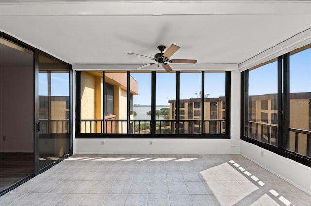 unfurnished sunroom with ceiling fan