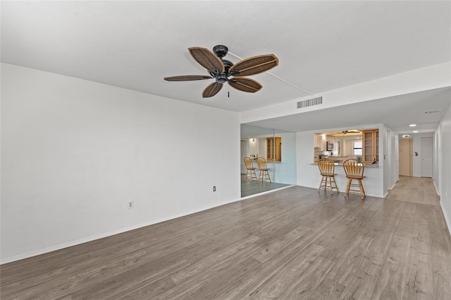 unfurnished living room featuring light hardwood / wood-style flooring and ceiling fan