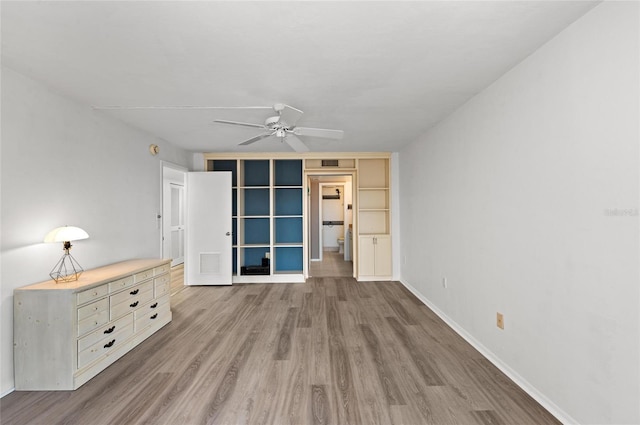 unfurnished living room with light hardwood / wood-style flooring and ceiling fan