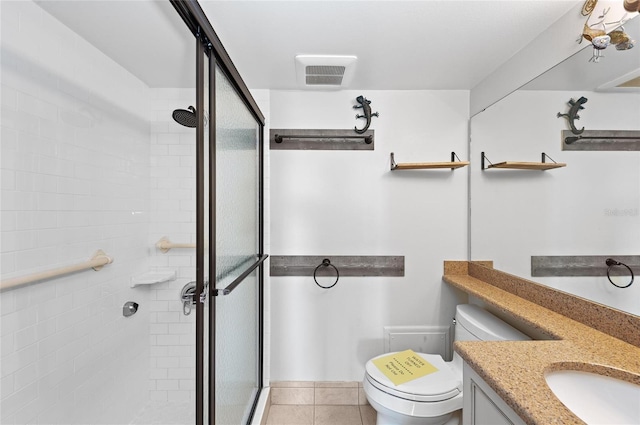 bathroom with tile patterned flooring, vanity, an enclosed shower, and toilet