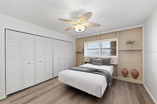 bedroom with hardwood / wood-style flooring, ceiling fan, and a closet