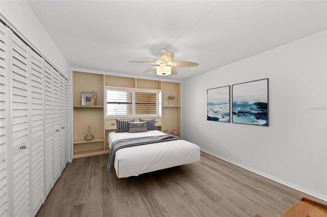 bedroom with wood-type flooring, a closet, and ceiling fan