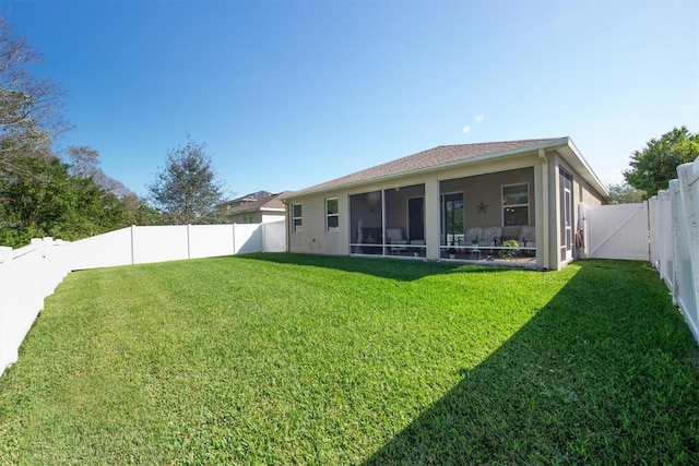 5718 Broad River Run, Ellenton, FL 34222 - rear view of property featuring a sunroom, a fenced backyard, and stucco siding