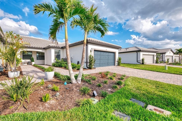 mediterranean / spanish home with a garage and a front lawn