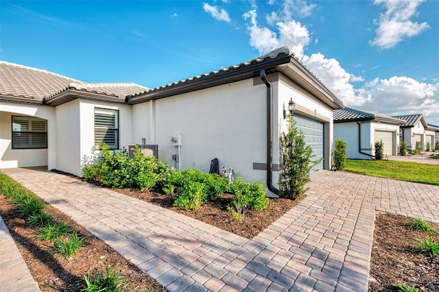 view of side of property featuring a garage