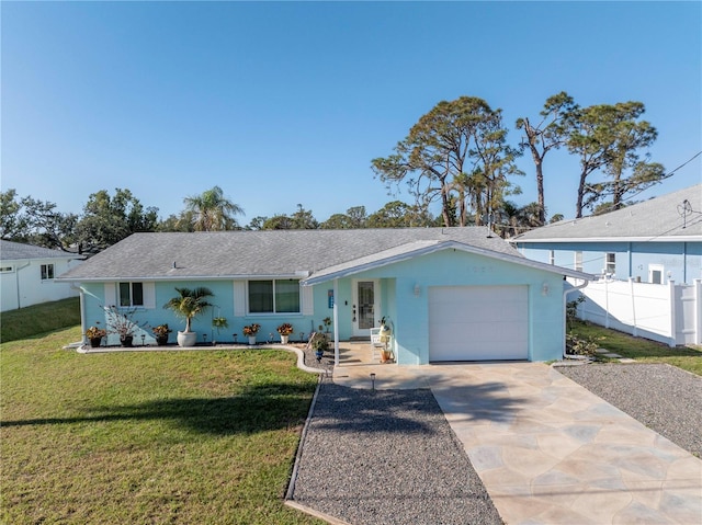 ranch-style home featuring a garage and a front lawn