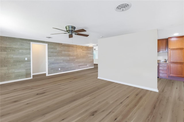 spare room featuring light hardwood / wood-style flooring and ceiling fan