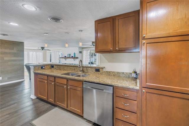 kitchen featuring light stone counters, dishwasher, sink, and kitchen peninsula