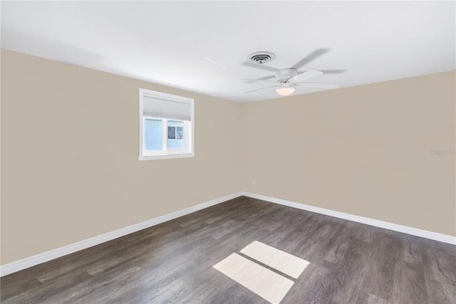 empty room with dark wood-type flooring and ceiling fan