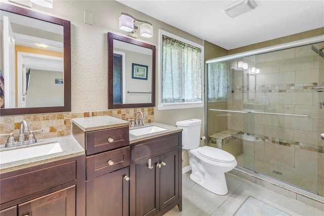 bathroom featuring tasteful backsplash, toilet, tile patterned floors, and a shower with shower door