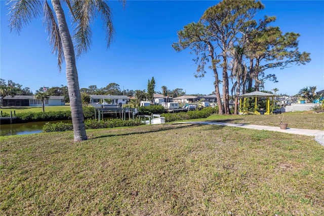 view of yard with a gazebo and a water view