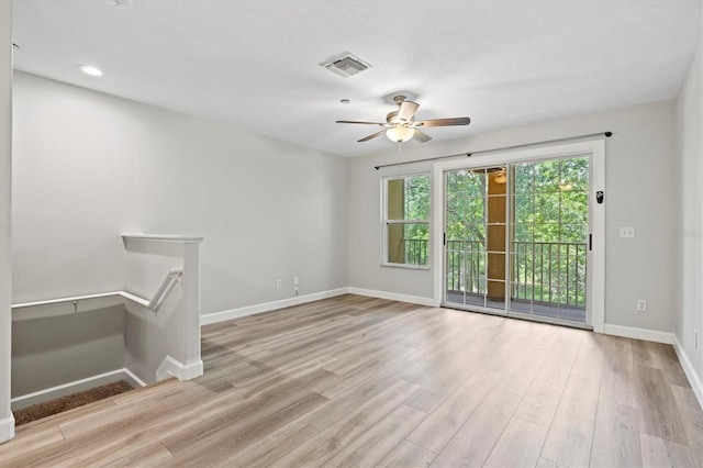 empty room featuring ceiling fan and light hardwood / wood-style floors