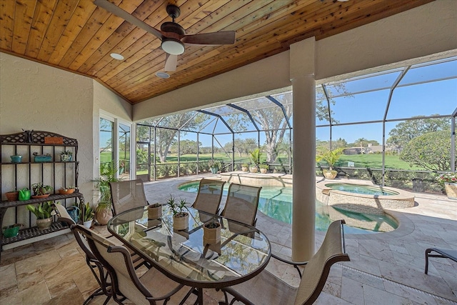 sunroom featuring a swimming pool with hot tub and a patio area